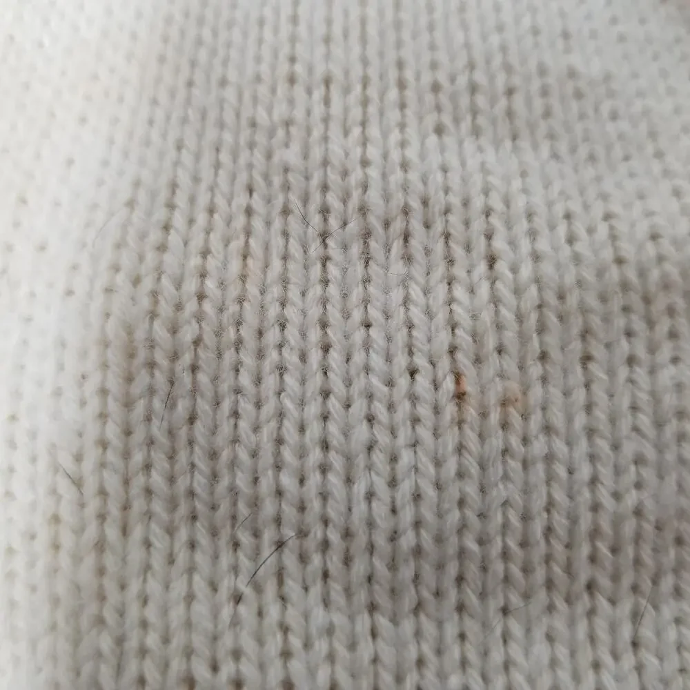small girl doggie light sweater  one small faint stain on underside of sweater